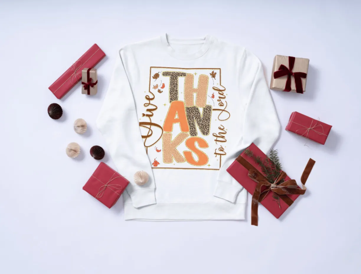 White Give Thanks to the Lord long sleeve shirt with gifts around it.